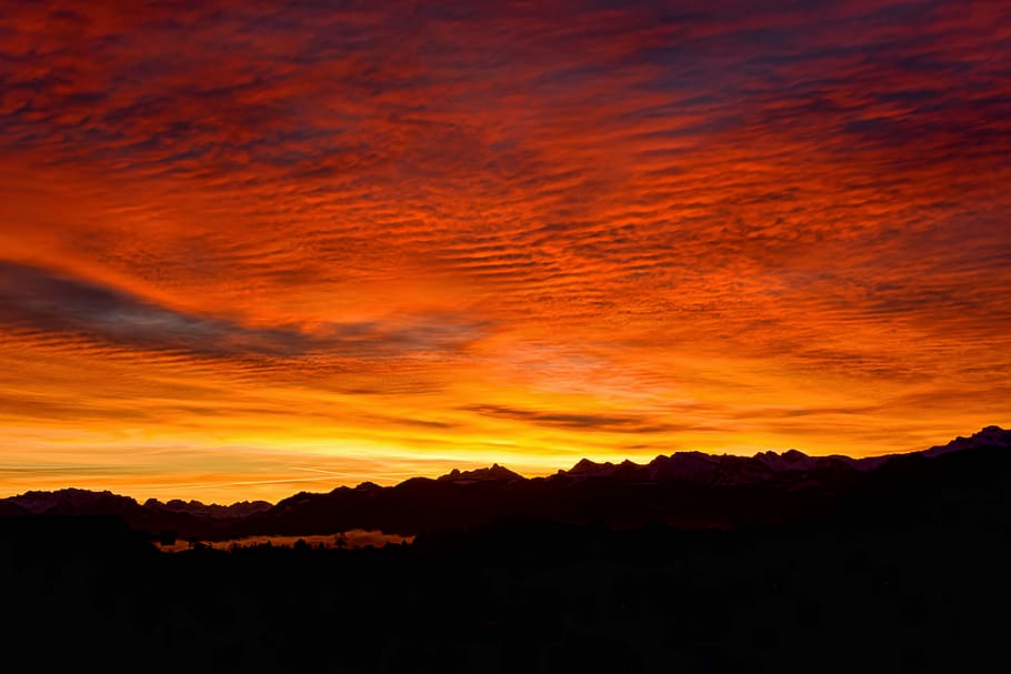 silhouette of mountains during golden hour, silhouette of mountain under red sea clouds HD wallpaper