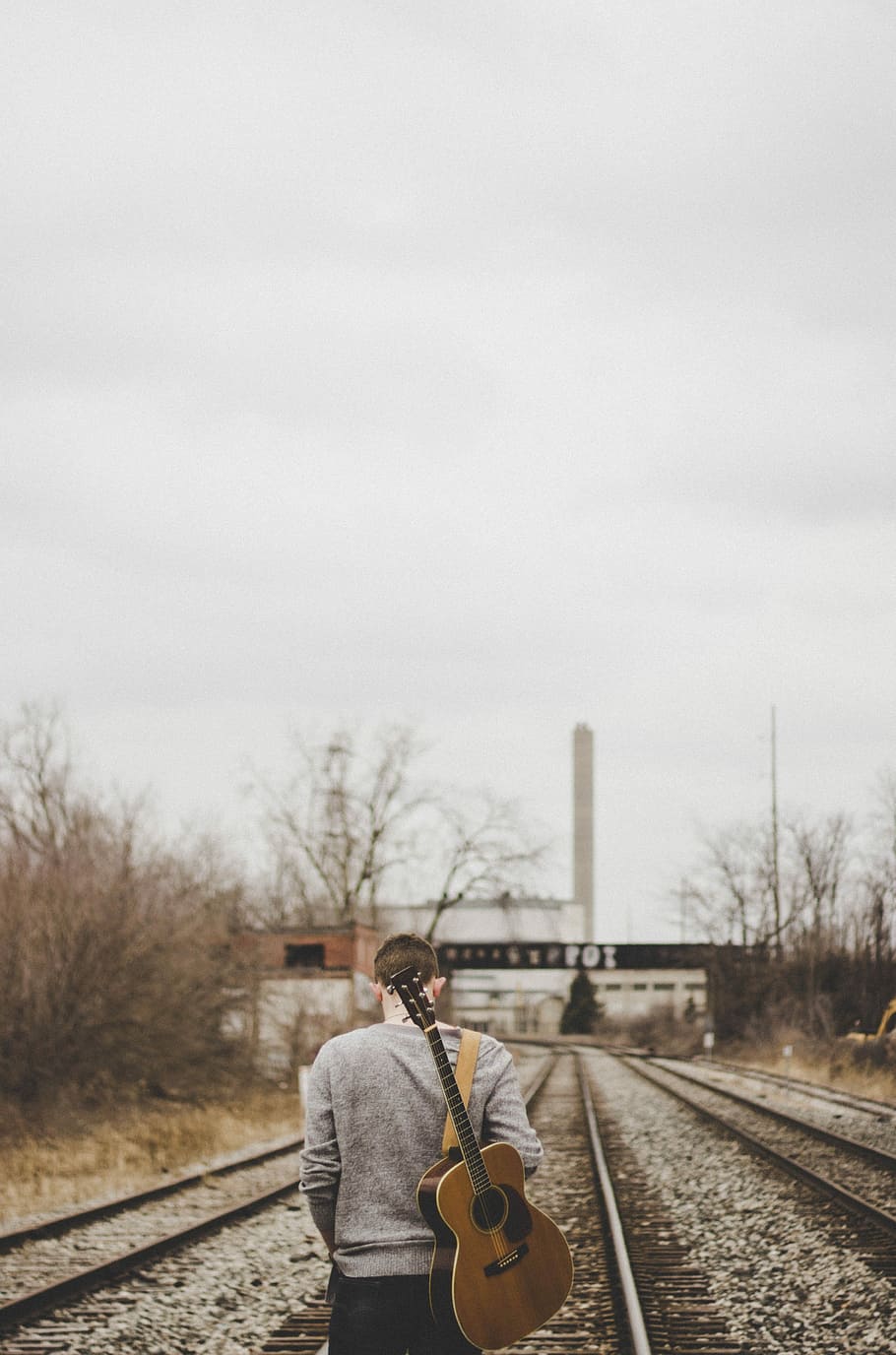 man carrying guitar walking on train rails, person holding guitar walking on train tracks, HD wallpaper