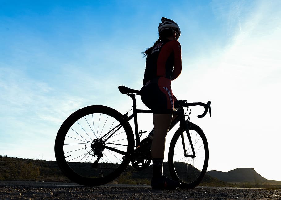 woman on road bike during daytime, bicycle rider, resting, silhouette