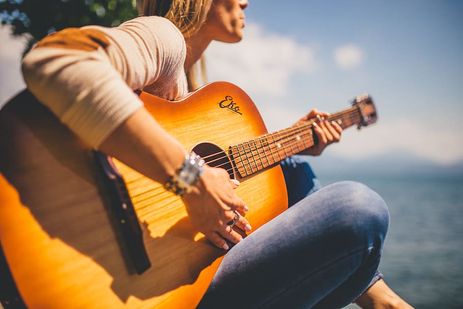 woman wearing sweatshirt playing acoustic guitar, musician, girl