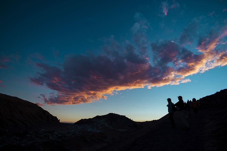 silhouette of people under cloudy sky, person on top of mountain during sunset HD wallpaper