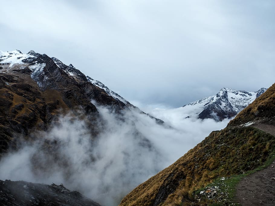 snow cover mountain with gray cloudy skies, green mountain with fog HD wallpaper