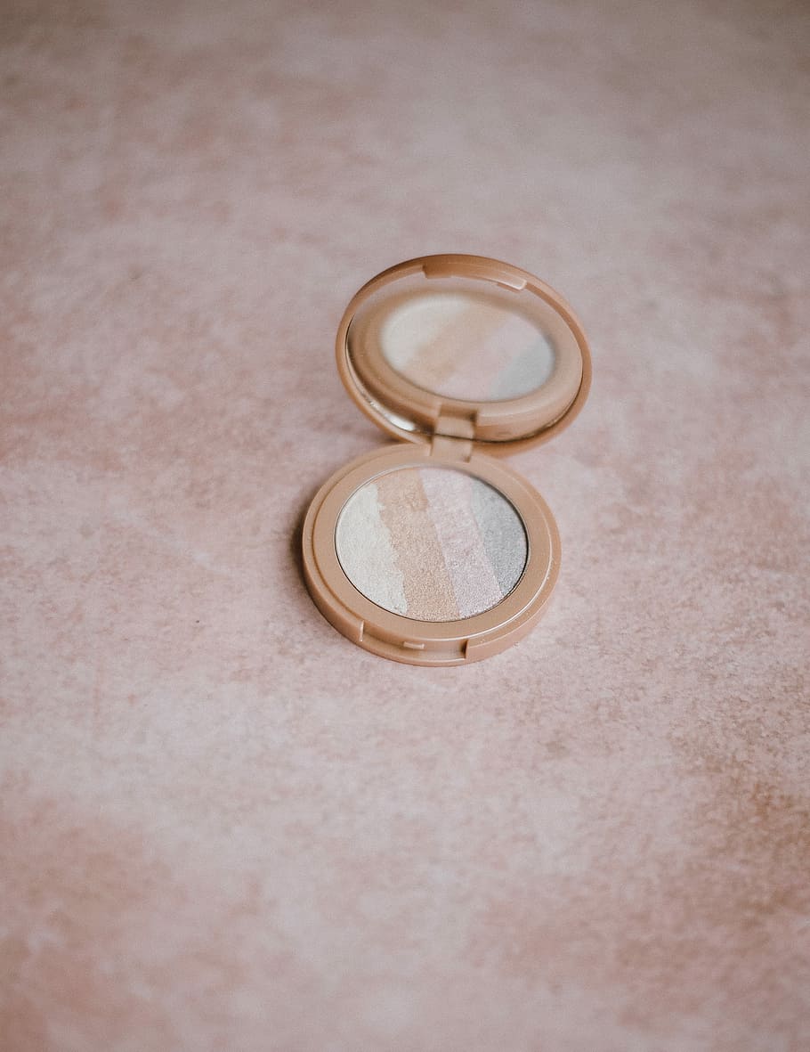 Make up highlighter, round beige compact powder on beige surface HD wallpaper