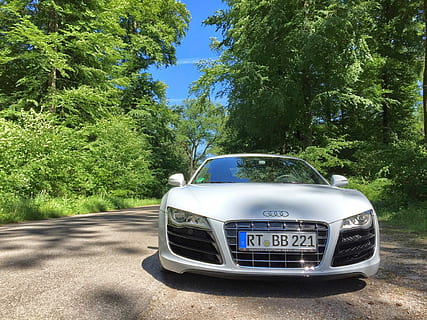 white Audi vehicle near green leafed trees under clear blue sky during daytime HD wallpaper