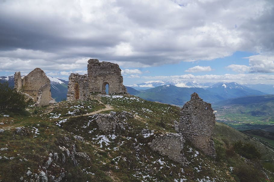 stone ruins under cloudy sky, gray concrete ruins on top of hill under cloudy sky HD wallpaper