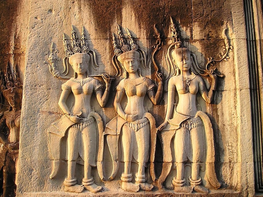 three women carved on the rocks, angkor, wat, cambodia, temple