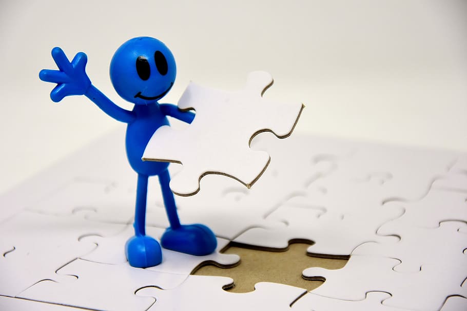 blue human figure holding puzzle piece, last part, success, finishing