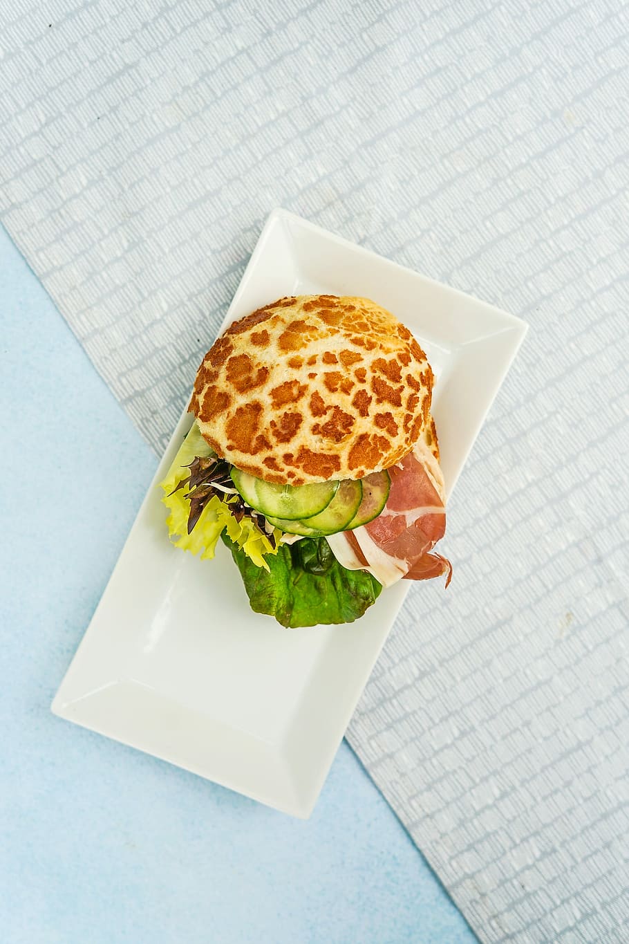 flat-lay photo of pancake with bacon, closeup photo of vegetable burger on plate