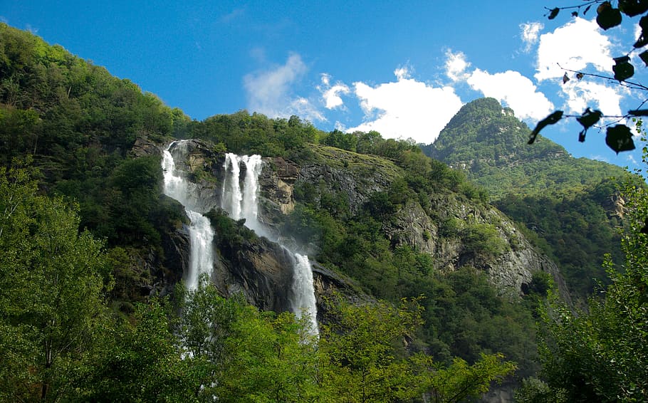 waterfalls near tree under white and blue sky during daytime photography HD wallpaper