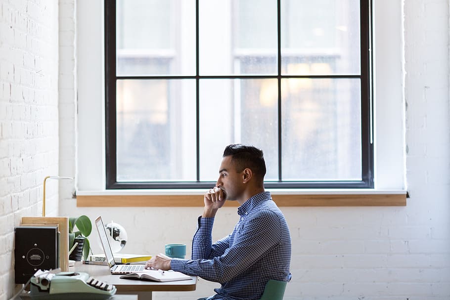 man wearing blue dress shirt sitting on green chair, laptop HD wallpaper