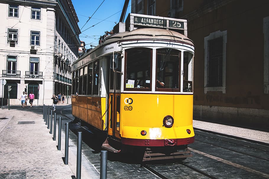 A yellow tram on the streets of Lisbon in Portugal, urban, cable Car