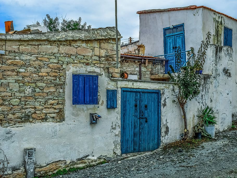 white concrete house with blue door, architecture, traditional
