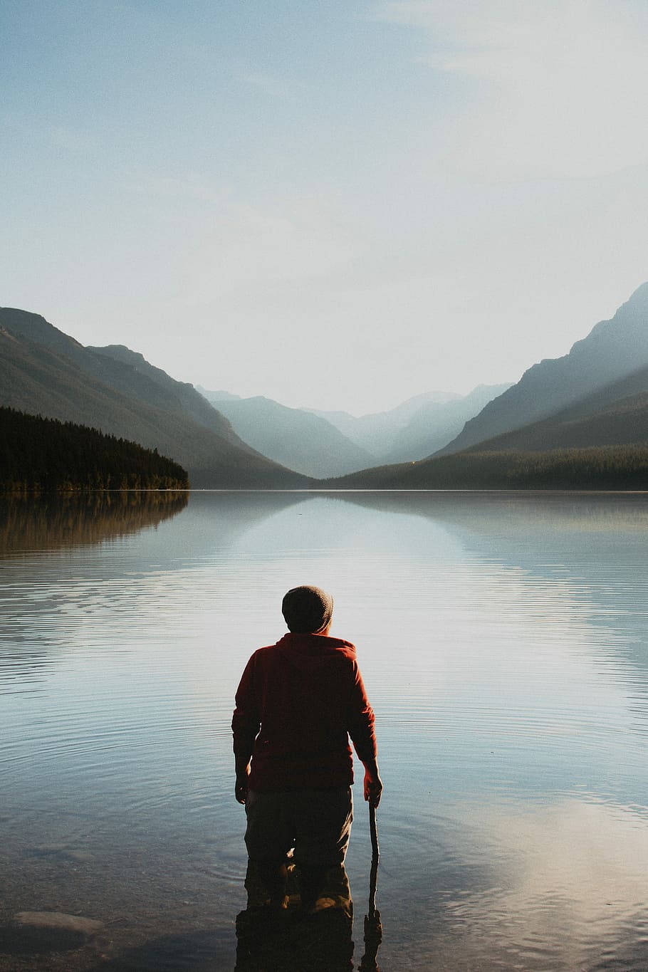 person standing on the lake in the middle of mountains, man standing on body of water facing mountain at daytime, HD wallpaper