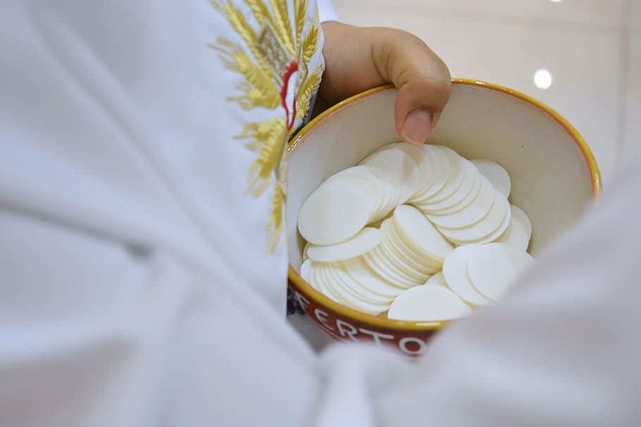 selective focus of holy host in bowl, communion, christ, jesus