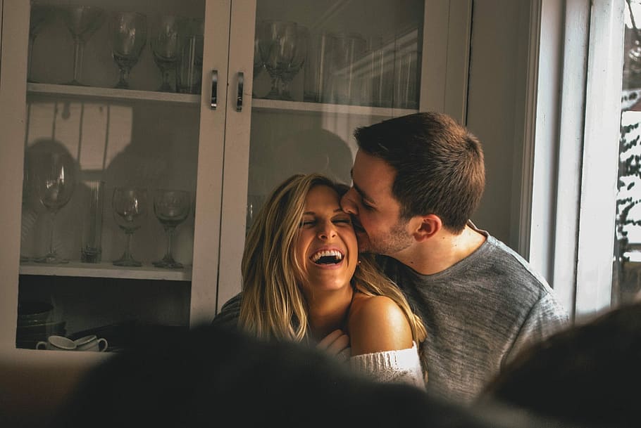 The giggles, man kissed woman's face in front of display cabinet HD wallpaper