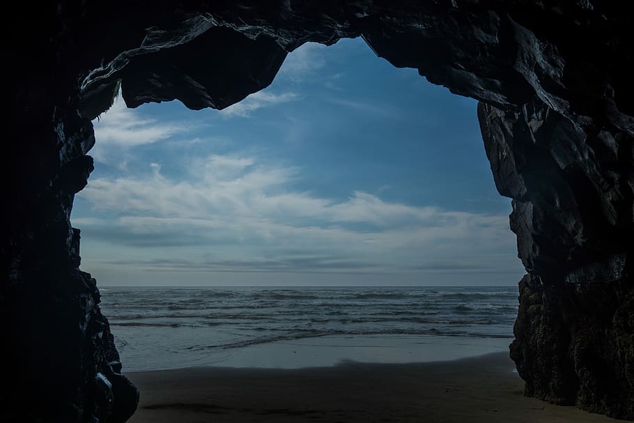 body of water under blue sky during daytime, cave near body of water during daytime HD wallpaper