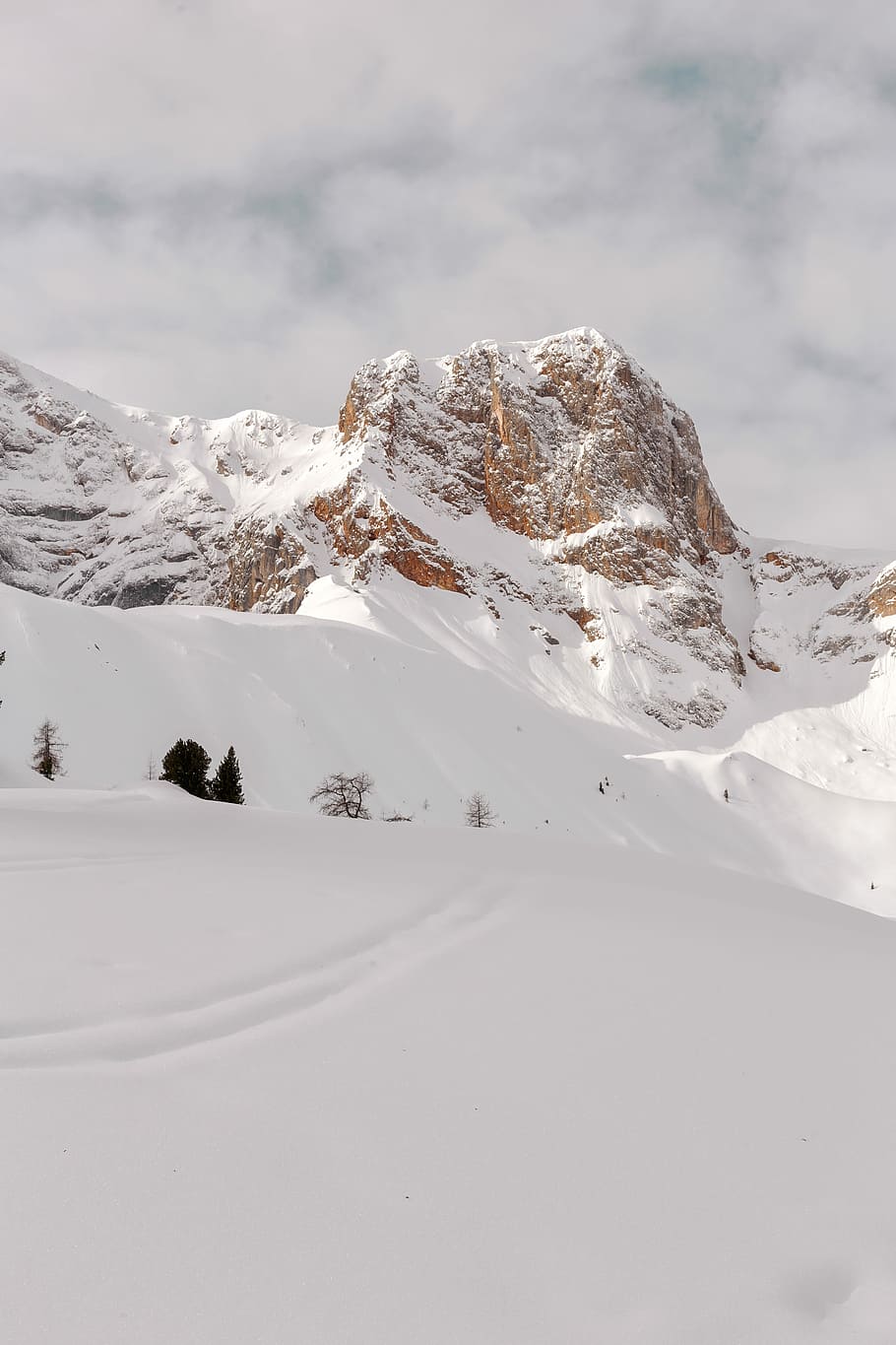 snow capped mountain under cloudy sky, brown mountain snow on top during daytime HD wallpaper