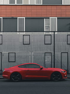 red Ford Mustang coupe parked beside the building, photo of red coupe HD wallpaper