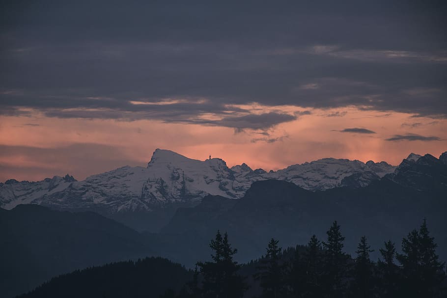 photo of trees near mountains covered with snow, photograph of mountain covered with snow during golden hour HD wallpaper