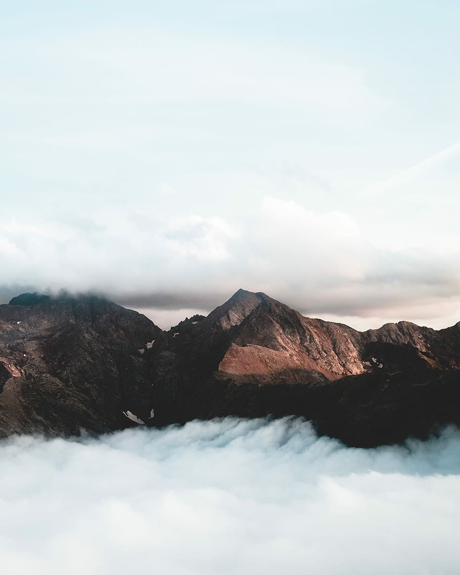 brown mountain under cumulus clouds, mountain peak surrounded by clouds HD wallpaper