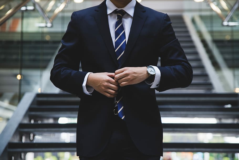 person standing near the stairs, man in front of grey staircase unbuttoning his black suit jacket, HD wallpaper