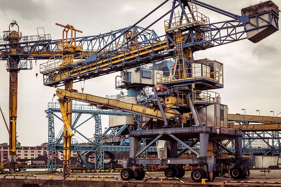 yellow and black tower crane, two yellow construction cranes HD wallpaper