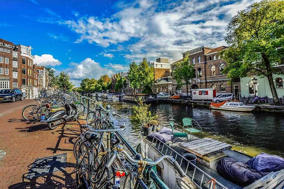 assorted-color bikes parked near body of water, Amsterdam, Dutch, Holland