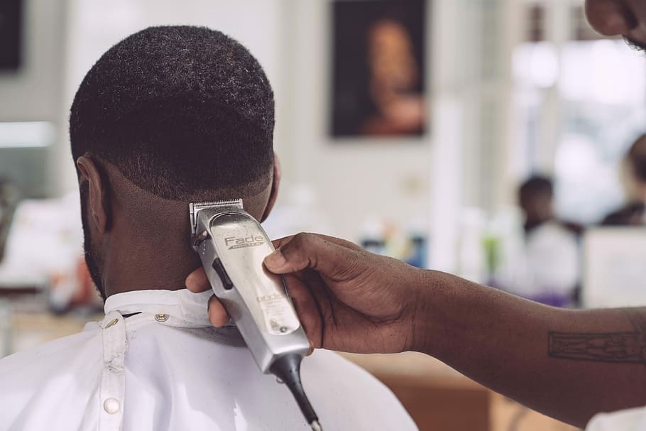 person holding hair clipper cutting the hair of man sitting, man trimming his person's hair, HD wallpaper