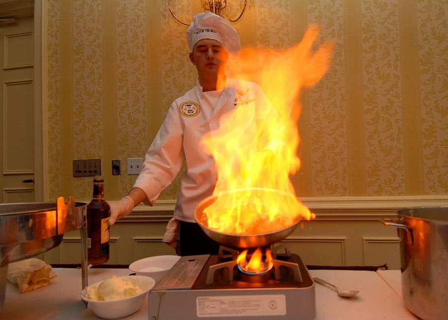 man cooking on portable stove while holding gray frypan, Chef HD wallpaper