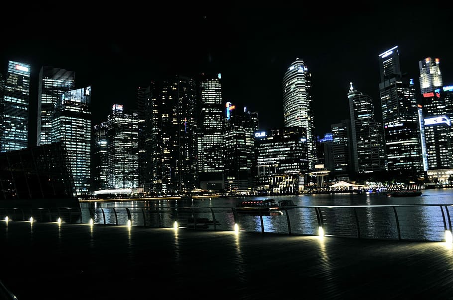 landscape photograph of high-rise buildings near body of water on a night setting HD wallpaper