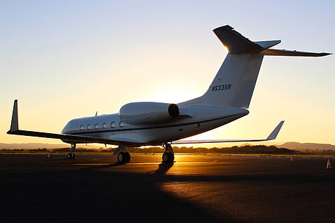 A light airplane sits on the airport runway at sunset, various HD wallpaper