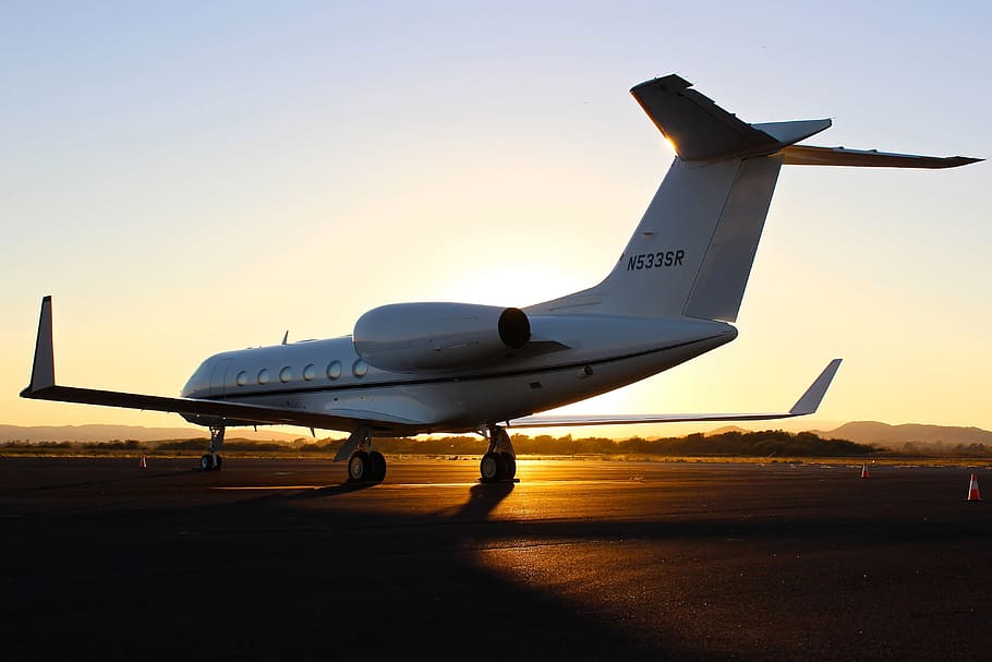 A light airplane sits on the airport runway at sunset, various HD wallpaper