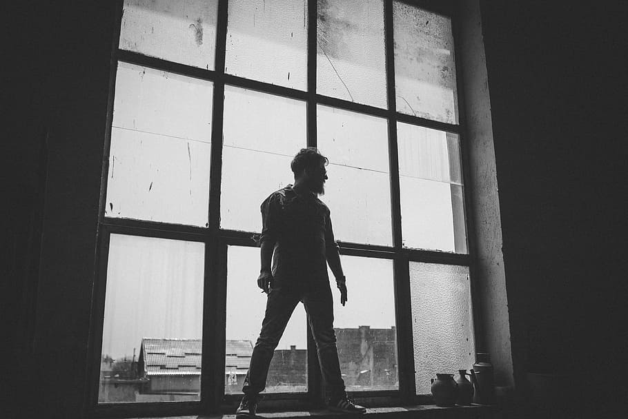 man standing against the glass window grayscale photography, silhouette of man standing in front of glass window HD wallpaper
