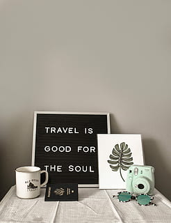 teal Instax Mini 8 instant camera near decor, photo of mug, quote print board, passport, sunglasses, and instant camera on table HD wallpaper