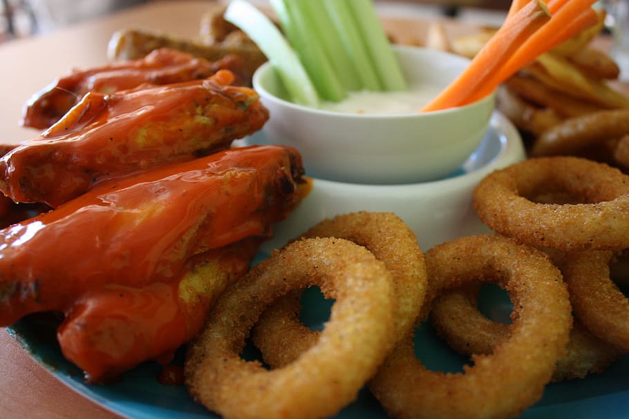close-up photo of deep-fried onions with seafood on plate, onion rings