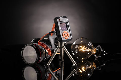 black Canon DSLR camera with bulb, Canon DSLR camera beside light bulb HD wallpaper