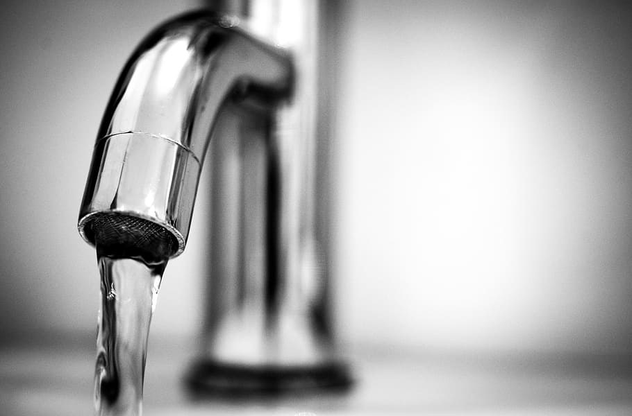 flowing water in faucet, tap, black and white, macro, silver