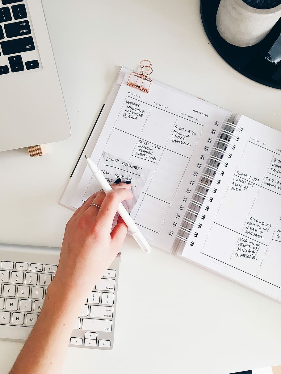 person holding notepad and pen flat lay photography, person holding pen on notebook HD wallpaper
