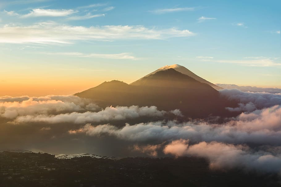 mountain over bed of clouds, mountain summit above clouds during sunset HD wallpaper