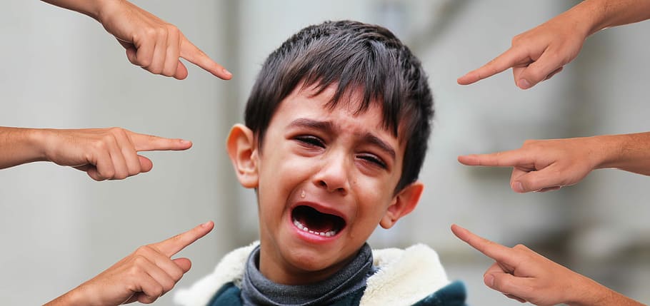 crying boy with six fingers pointing at him, bullying, child