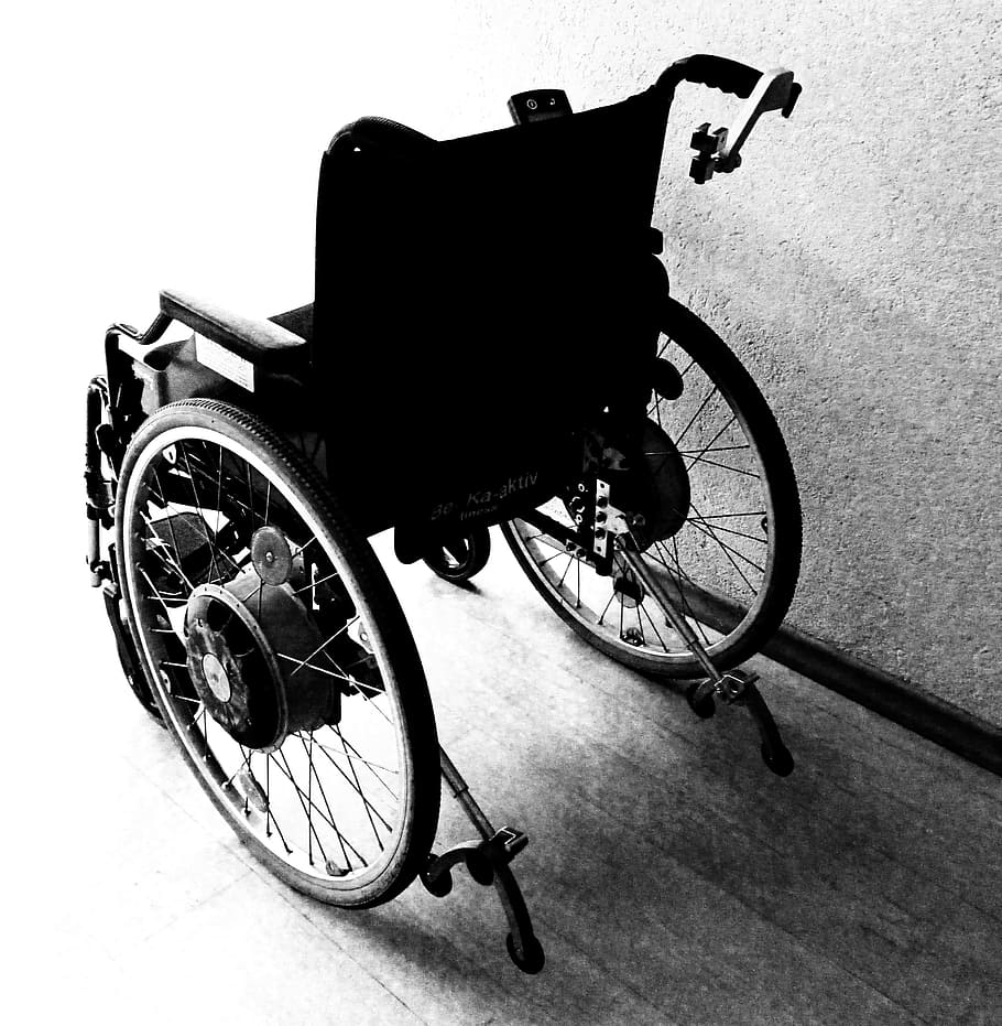 black wheelchair near gray concrete wall, disability, accident
