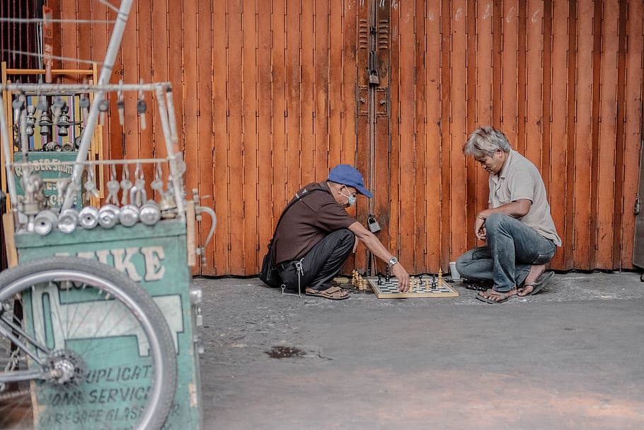 two men playing chess, photo of two person playing chess beside roller shutter, HD wallpaper