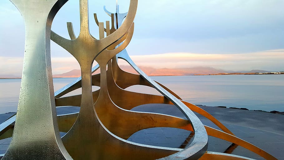 Iceland boat sculpture, brown wooden structure near body of water HD wallpaper