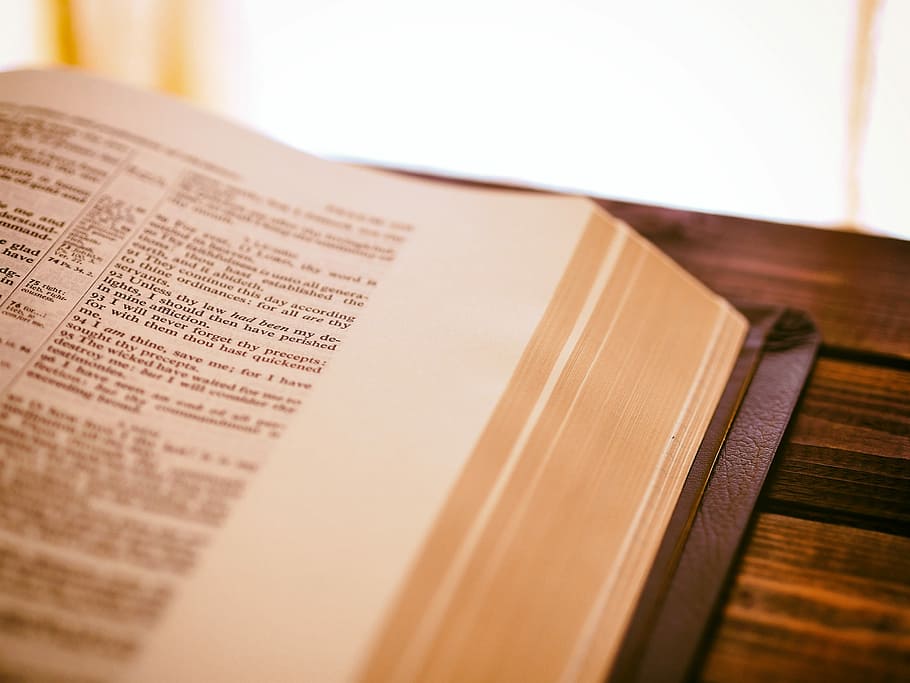 book page on top of brown surface, close-up photo of bible on table, HD wallpaper