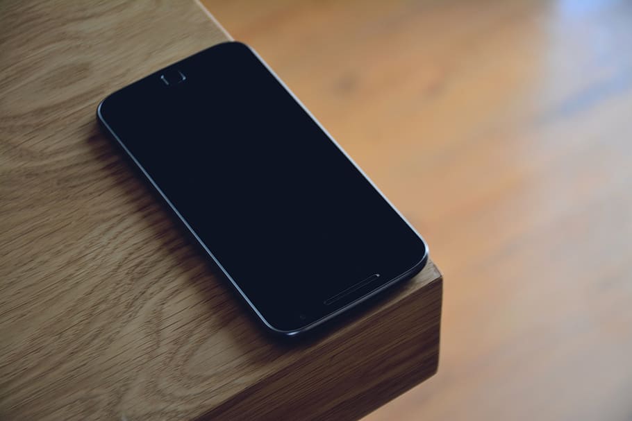 black Android smartphone on edge of table, mobile, cellphone, HD wallpaper