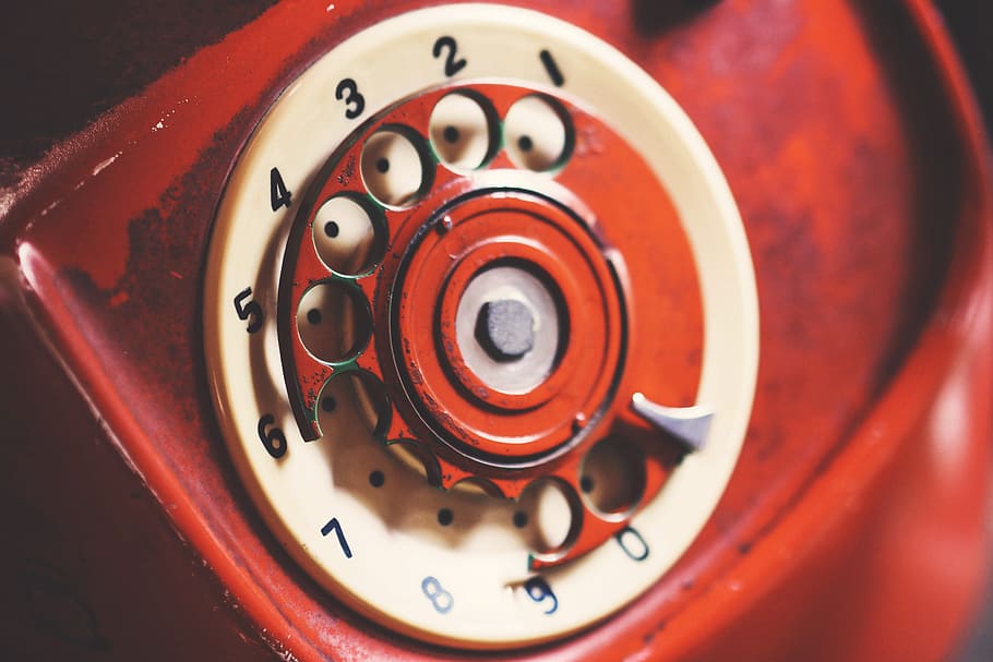 red and white rotary phone selective focus photography, aged