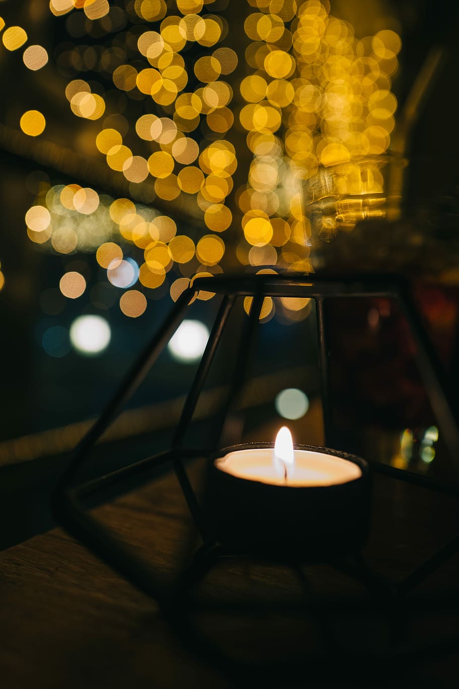 white candle on black candle holder, tealight with bokeh lights background HD wallpaper