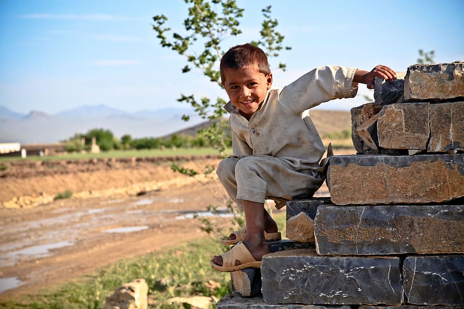 boy in gray shirt on pile of bricks, child, kid, climbing, stone wall HD wallpaper
