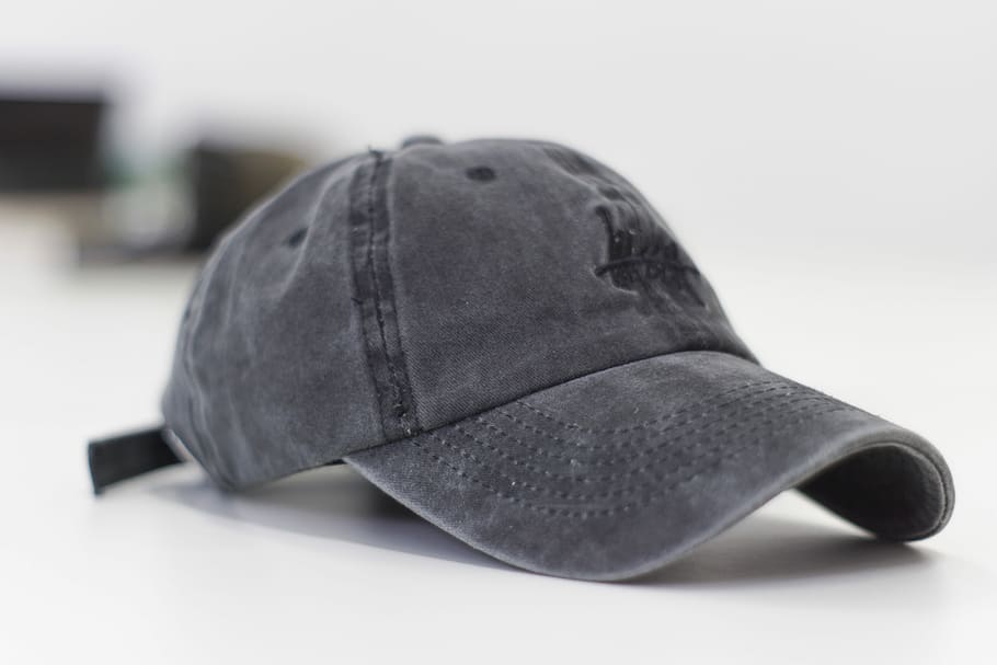 gray baseball cap on white surface, closeup photo of gray curve-brimmed cap HD wallpaper
