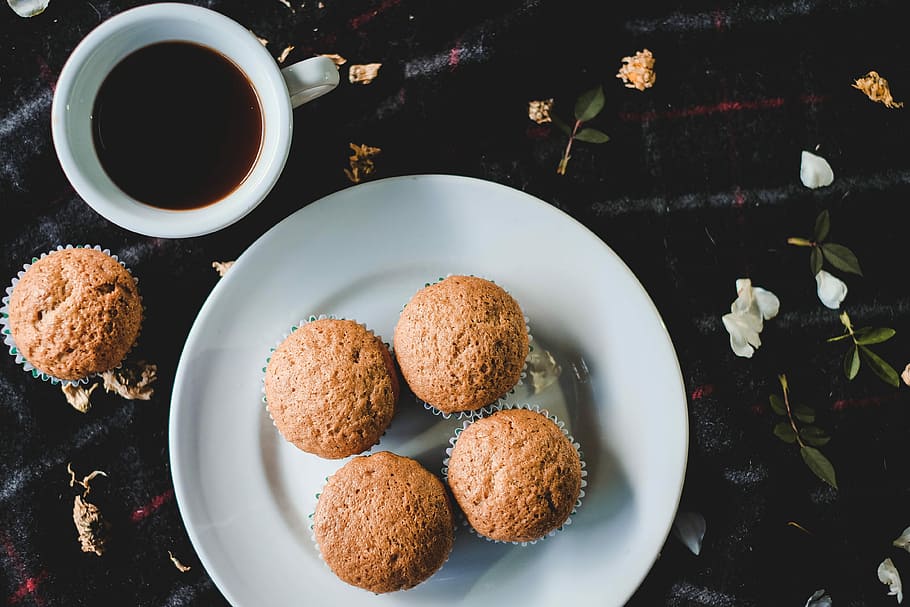white ceramic plate with muffins, four muffins on white ceramic plate beside mug with black liquid HD wallpaper